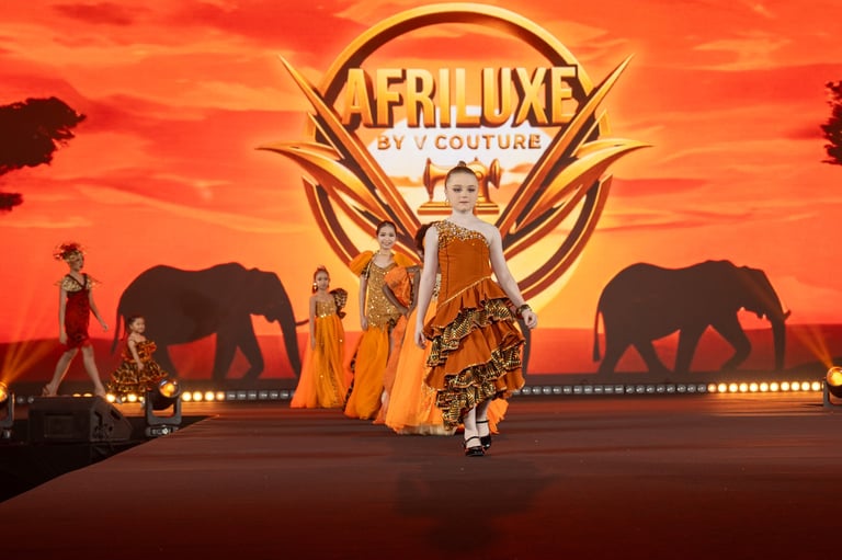 Cirque du Soleil Afroxe stage production with performers in golden costumes against African sunset backdrop with elephant silhouettes